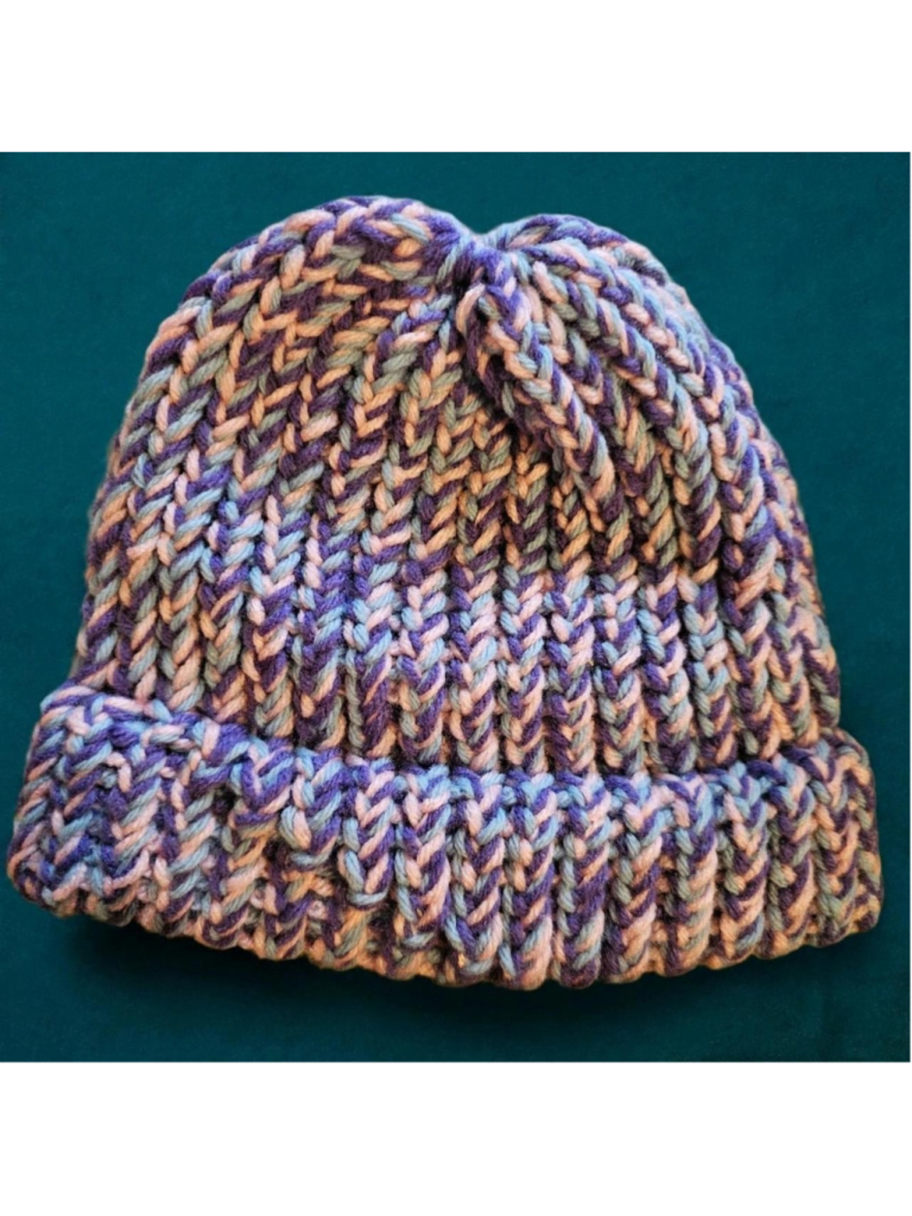 Multi-colored knit beanie with purple, blue, and beige yarn #knitbeanie #winter